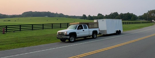 Hauling Heroes truck pulling an enclosed trailer